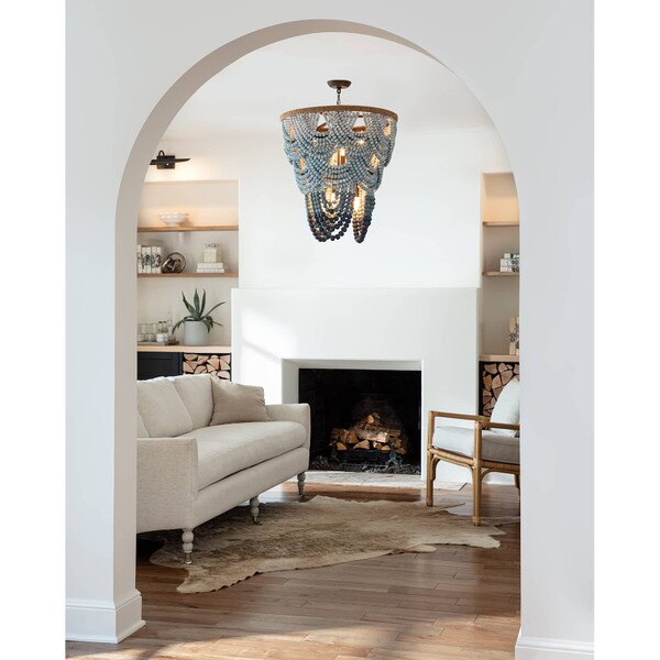 White arched living room with a wood beaded chandelier